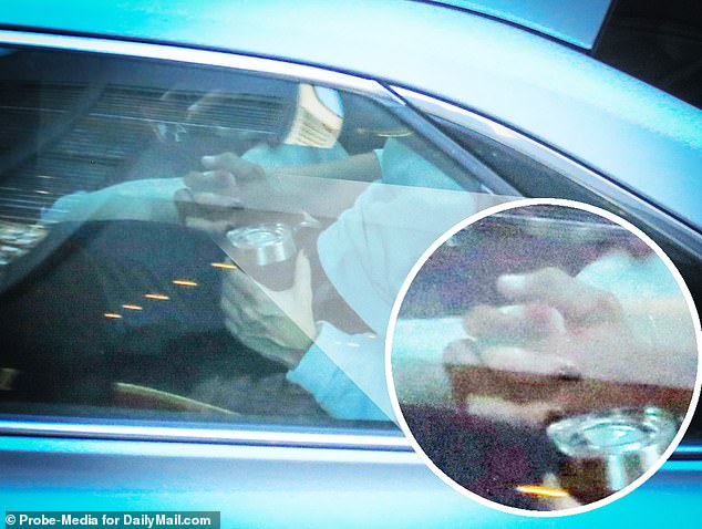 Later that afternoon, the couple were caught in a rare PDA moment as they held hands in the back of an Uber while heading to Robach's apartment