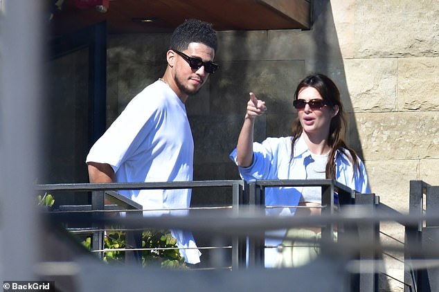 Two years together: During their exchange, the five-foot-nine beauty playfully stuck her tongue out at Booker and inched closer and closer to him as they spoke on a beachfront balcony