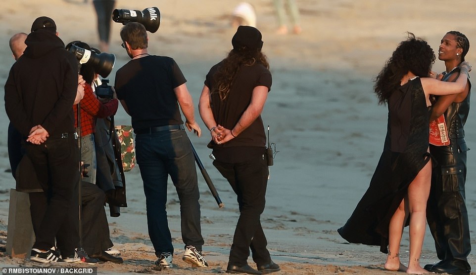 Workday: Rihanna could be seen barefoot on the sun drenched shoreline wearing a long flowing halter-neck dress with a white embellishment as she doted on her new son and boyfriend, fixing their outfits for the shoot