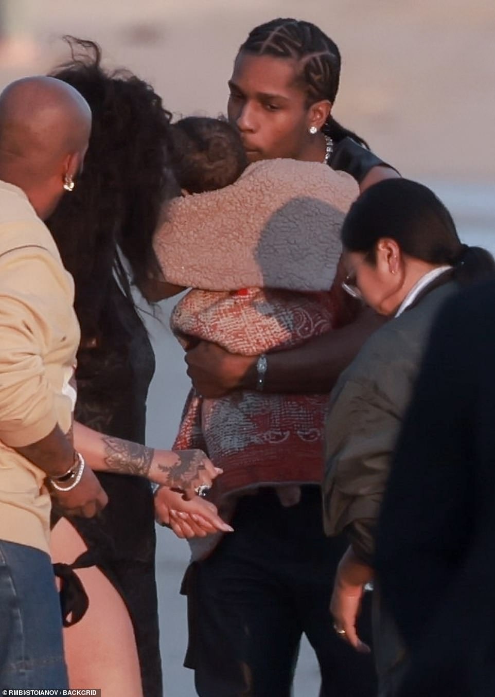 Joy: A$AP Rocky was the image of paternal bliss as he cradled his infant on the beach