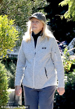 Long sported a casual look including a blinged-out gray baseball cap and a gray LL Bean zip-up
