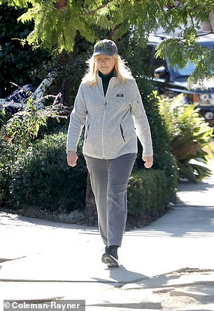 The actress also wore a black turtleneck and gray sweatpants