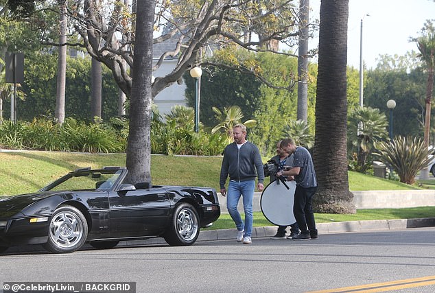 Zipping a grey hoodie over a white t-shirt and modeling a pair of fashionably faded jeans, Ian had grown a beard over his matinee idol features