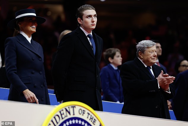 epa11840653 (L-R) First lady Melania Trump, Baron Trump, and Viktor Knavs look on during an indoor inauguration parade at the Capital One Arena in Washington, DC, USA, 20 January 2025. Trump was sworn in for a second term as president of the United States on 20 January. The presidential inauguration was held indoors due to extreme cold temperatures in DC. EPA/ANNA MONEYMAKER / POOL