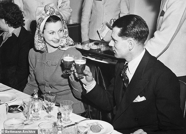 She would spend long nights in her bungalow knocking back way too much gin and playing canasta (photographed with Olivier)