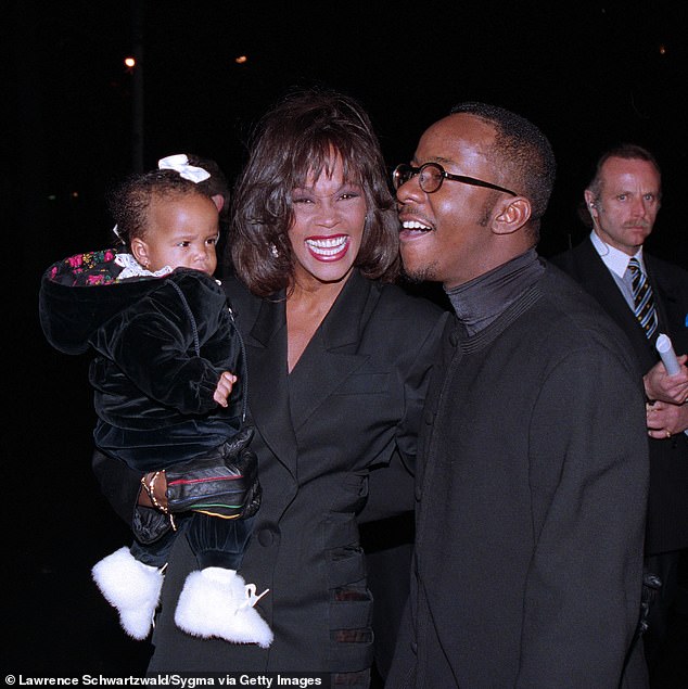 The singer with husband Bobby Brown and Bobbi Kristina - David Roberts is in the background